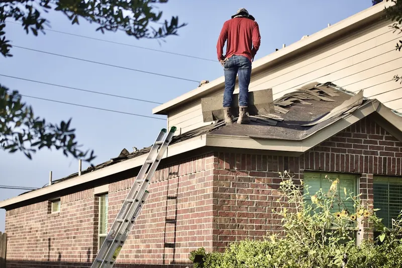 Professional roofer working on a residential roof in River Vale